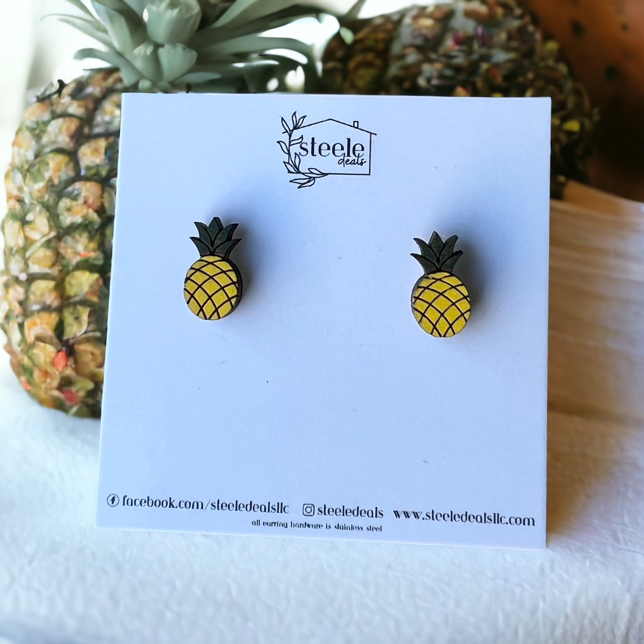 wood stud earrings in the shape and color of a pineapple