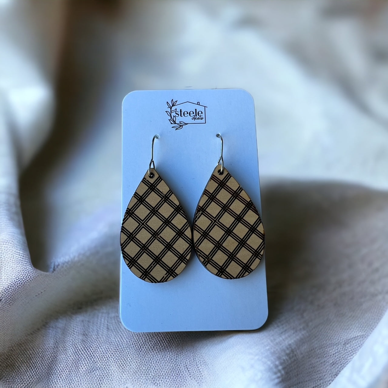 teardrop wood dangle earrings with a criss cross design