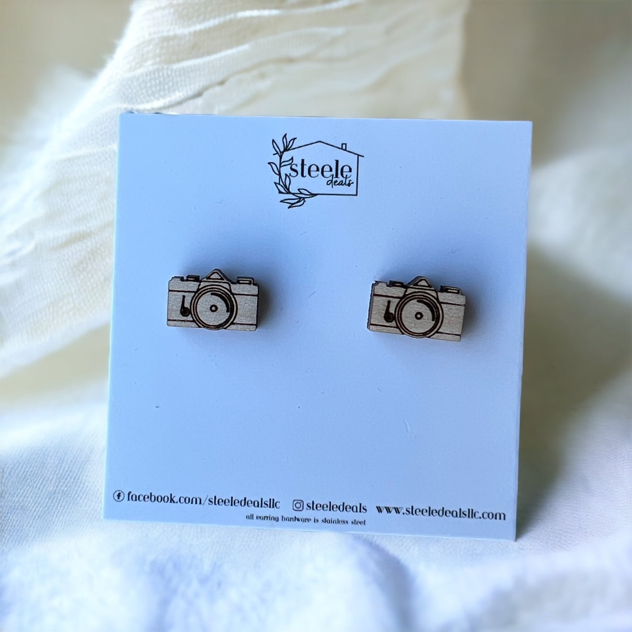 laser cut wood stud earrings in the shape of a camera