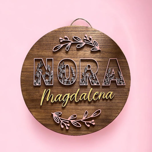 wooden circle sign with personalization of first and middle name and wild flowers