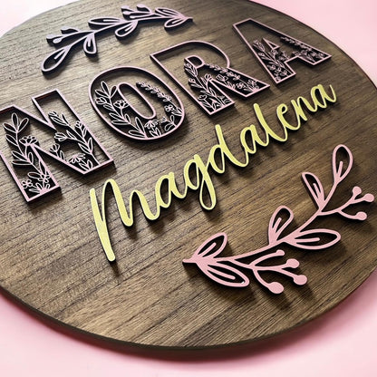 wooden circle sign with personalization of first and middle name and wild flowers