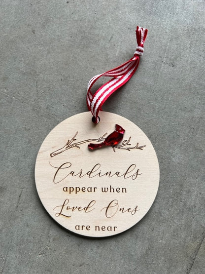 wooden ornament with a red cardinal sitting on branch. Quote reads "Cardinals appear when loved ones are near"