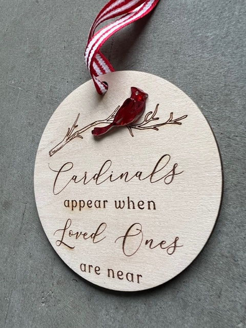 wooden ornament with a red cardinal sitting on branch. Quote reads "Cardinals appear when loved ones are near"