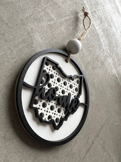 black and white wooden ornament with Ohio state shape and Home text across the center