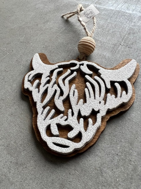 wooden ornament in the shape of a highland cow