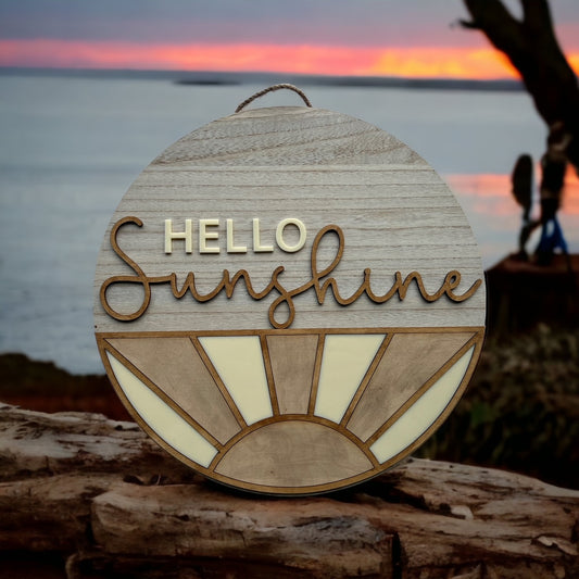 wood and acrylic sign with the quote "hello sunshine" on the top half and sun rays on the bottom half
