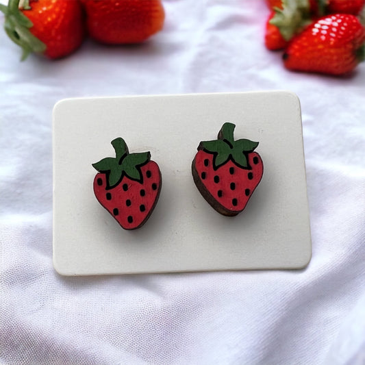 hand painted wooden stud earrings in the shape of a whole strawberry