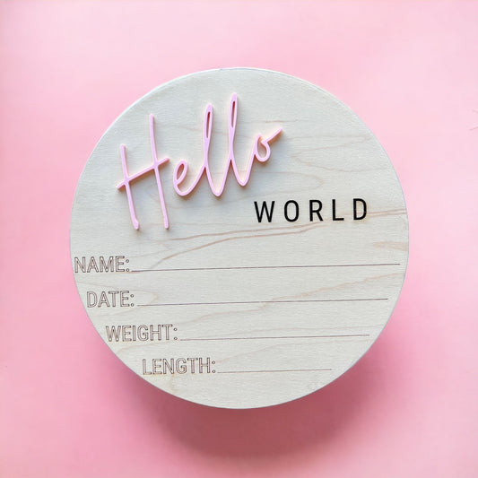 Wooden circle sign saying Hello world with spots for Name, date, weight, and length