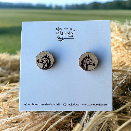 wood stud earrings in the shape of a circle with laser cut horse design