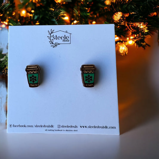 wood stud earrings in the shape of a travel coffee cup with green sleeve and snowflake in the center