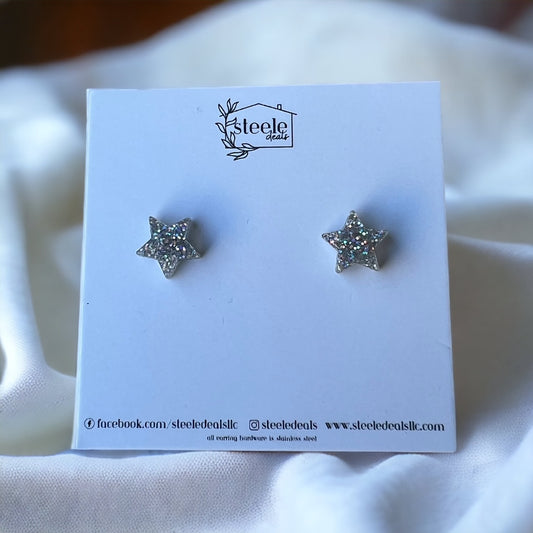 acrylic stud earrings in the shape of a star with silver glitter design