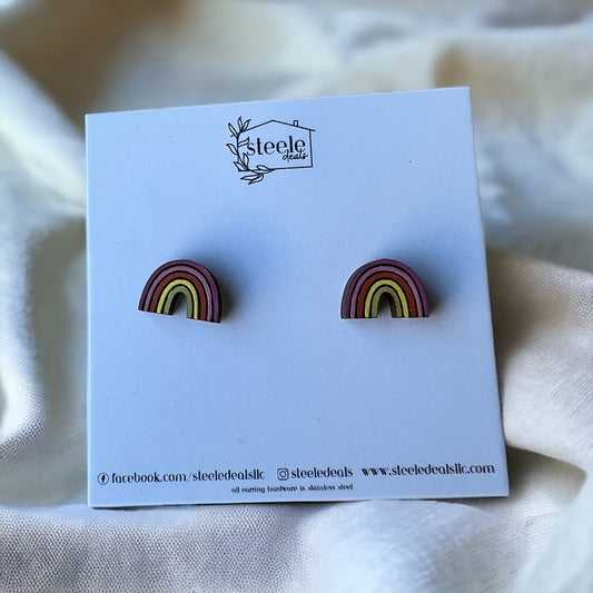 hand painted wood stud earrings in the shape of a rainbow