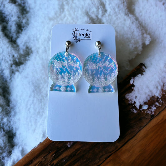 snowglobe shapped earrings with Santa in the night sky and tree line