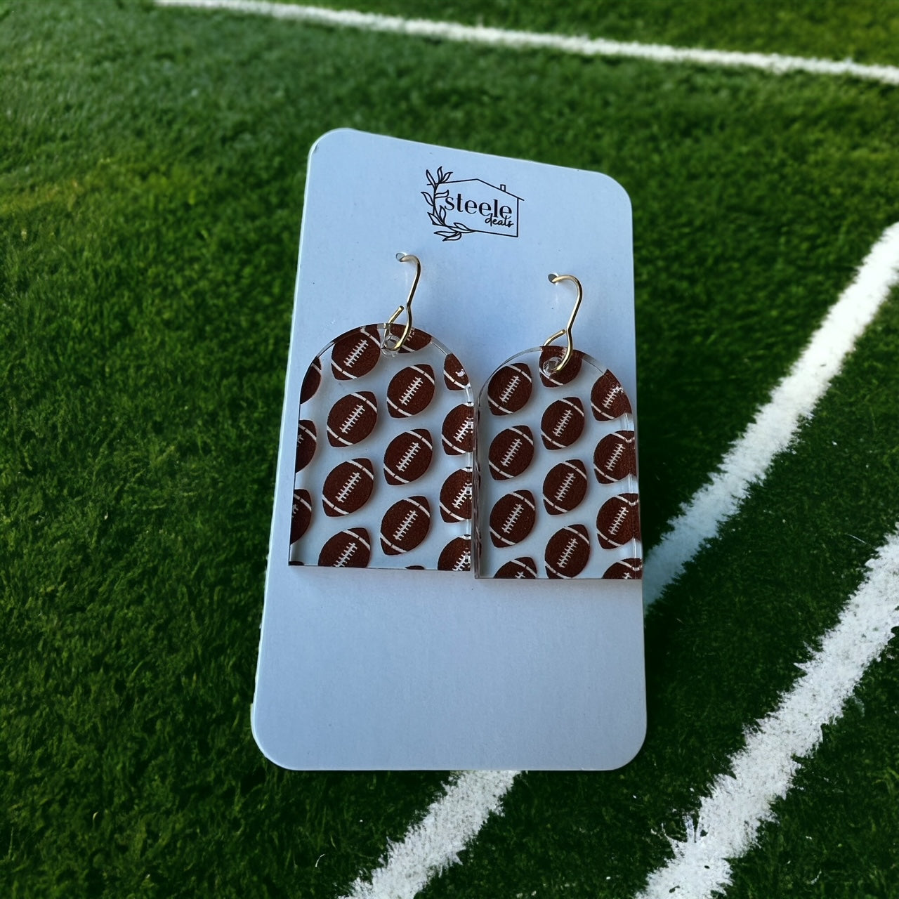 football pattern on arched dangle earrings  Edit alt text