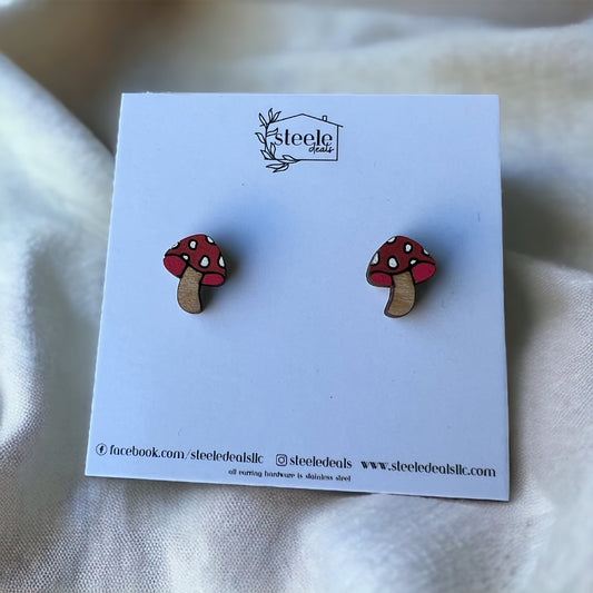 wood stud earrings in the shape of a mushroom with a red and white spot top